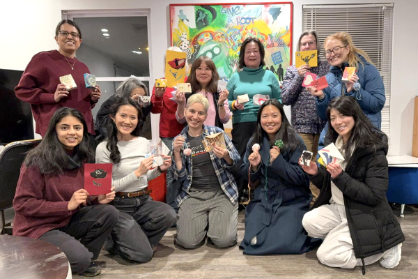 Twelve participants in a Valentine's workshop show off their creations.