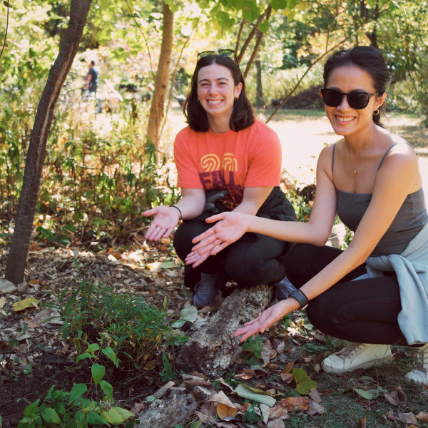 Two volunteers posing with a recently planted native plant.